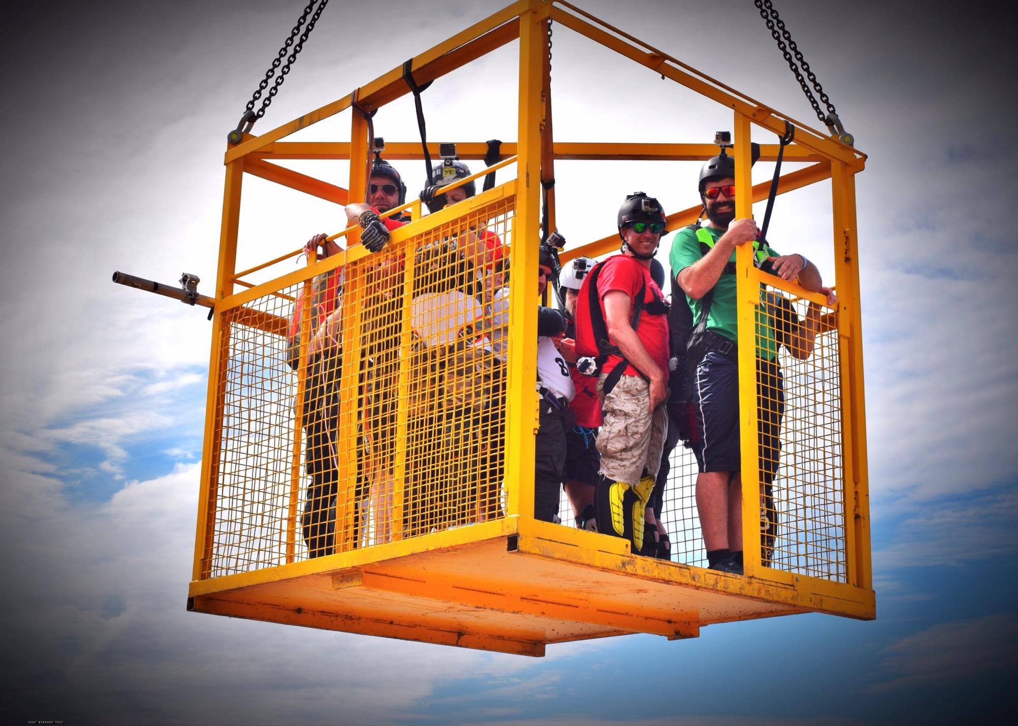 Going up in the cage to jump the crane