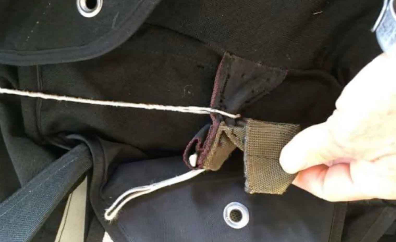 Line caught around closing tab, so main canopy did not release properly when cut away